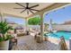 Luxurious covered patio with ample seating overlooks the sparkling pool, creating an ideal space for entertaining and relaxation at 20437 W White Rock Rd, Buckeye, AZ 85396