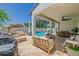 Spacious covered patio with a full outdoor kitchen and ample seating overlooks the sparkling pool, perfect for entertaining at 20437 W White Rock Rd, Buckeye, AZ 85396