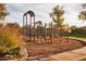 Community playground featuring swings, climbing structures, and a soft landing surface at 20437 W White Rock Rd, Buckeye, AZ 85396
