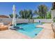 Beautiful backyard with a sparkling pool, charming waterfall feature, and ample lounge space for outdoor enjoyment at 20437 W White Rock Rd, Buckeye, AZ 85396