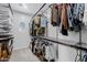 Organized walk-in closet with shelving, hanging racks, and a charming window for natural light at 20437 W White Rock Rd, Buckeye, AZ 85396