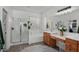Bright bathroom featuring a separate shower, tub, and vanity area with wood cabinets at 2056 E Carob Dr, Chandler, AZ 85286