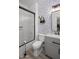 Updated bathroom with modern fixtures, a tiled shower, and stylish floral wallpaper at 2056 E Carob Dr, Chandler, AZ 85286
