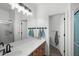Bright bathroom featuring a wide mirror, modern lighting, and a convenient towel rack by an open doorway at 2056 E Carob Dr, Chandler, AZ 85286