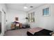 Inviting bedroom featuring a desk, bed, and natural light from a large window at 2056 E Carob Dr, Chandler, AZ 85286