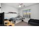 Comfortable bedroom with space-saving furniture, natural light, and a modern ceiling fan at 2056 E Carob Dr, Chandler, AZ 85286