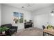 Cozy bedroom with a piano, accent chair, and large window with natural light at 2056 E Carob Dr, Chandler, AZ 85286