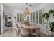 Charming dining room with wood table, chandelier, and large windows with white shutters at 2056 E Carob Dr, Chandler, AZ 85286