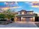 Two-story home with a three-car garage, tile roof, and well-manicured landscaping at 2056 E Carob Dr, Chandler, AZ 85286