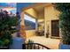 Charming front porch with stone columns, outdoor seating, and flowering plants at 2056 E Carob Dr, Chandler, AZ 85286