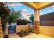 Covered front porch with stone accents, mature landscaping, and an inviting entrance at 2056 E Carob Dr, Chandler, AZ 85286