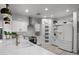 Bright white kitchen with stainless steel appliances, quartz countertops, and open shelving at 2056 E Carob Dr, Chandler, AZ 85286