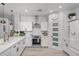 Modern white kitchen featuring stainless steel appliances, quartz countertops, and subway tile backsplash at 2056 E Carob Dr, Chandler, AZ 85286