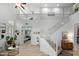 Bright, open living room with soaring ceilings, white walls, and a staircase leading to a second level at 2056 E Carob Dr, Chandler, AZ 85286