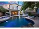 Spacious pool, spa, rock waterfall, covered patio, and outdoor seating for entertaining at 2056 E Carob Dr, Chandler, AZ 85286