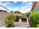 Quiet backyard with desert landscaping and a firepit that is surrounded by lounge seating and mature trees at 20684 W Meadowbrook Ave, Buckeye, AZ 85396