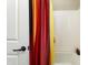 Bright bathroom with a colorful shower curtain and a clean, white shower/tub combo with a matching door at 20684 W Meadowbrook Ave, Buckeye, AZ 85396