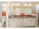 Bathroom features a double vanity with stylish fixtures, and a large mirror at 20684 W Meadowbrook Ave, Buckeye, AZ 85396
