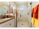Modern bathroom featuring a glass-enclosed shower with neutral tile and bronze hardware at 20684 W Meadowbrook Ave, Buckeye, AZ 85396