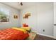 Bedroom featuring a small bench and orange bedding, offering a serene retreat at 20684 W Meadowbrook Ave, Buckeye, AZ 85396