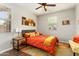 Bedroom featuring a ceiling fan, side tables and orange bedding at 20684 W Meadowbrook Ave, Buckeye, AZ 85396