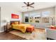 Bright bedroom featuring a ceiling fan, and large windows that provide ample natural light at 20684 W Meadowbrook Ave, Buckeye, AZ 85396