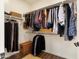 Walk-in closet with custom shelving for optimal storage, with wood-look flooring at 20684 W Meadowbrook Ave, Buckeye, AZ 85396