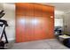 Spacious garage with a wall of wooden storage cabinets and a home gym that includes a treadmill at 20684 W Meadowbrook Ave, Buckeye, AZ 85396