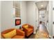 Hallway featuring seating and artwork, connecting to other rooms within the home at 20684 W Meadowbrook Ave, Buckeye, AZ 85396