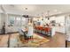 Open-concept kitchen with white cabinets, stainless appliances, island seating, and flows to the dining area at 20684 W Meadowbrook Ave, Buckeye, AZ 85396