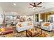 Bright, open-concept living room with modern furnishings and open access to the kitchen at 20684 W Meadowbrook Ave, Buckeye, AZ 85396