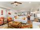 Open-concept living room flowing into a modern kitchen with white cabinetry and an island at 20684 W Meadowbrook Ave, Buckeye, AZ 85396