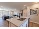Open-concept kitchen with island seating, modern appliances, and a view into the living area at 2121 W Sonoran Desert Dr # 45, Phoenix, AZ 85085