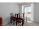 Cozy dining area with a modern table, four chairs, and sliding glass doors at 23112 E Twilight Dr, Queen Creek, AZ 85142