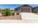 Charming single-story home with a well-manicured lawn and inviting two-car garage at 23112 E Twilight Dr, Queen Creek, AZ 85142