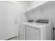 Well-equipped laundry room with modern washer and dryer units and ample shelving for storage at 23112 E Twilight Dr, Queen Creek, AZ 85142