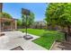 Backyard featuring a patio, basketball hoop, lawn, trees, and garden beds at 2461 E Stephens Pl, Chandler, AZ 85225