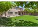 Spacious backyard featuring a lawn, covered patio, basketball hoop, and mature trees at 2461 E Stephens Pl, Chandler, AZ 85225