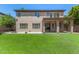 Expansive backyard featuring lush green lawn, covered patio, and basketball hoop at 2461 E Stephens Pl, Chandler, AZ 85225
