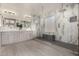 Luxurious bathroom featuring a spacious walk-in shower with marble accents, double vanity, and modern fixtures at 2461 E Stephens Pl, Chandler, AZ 85225