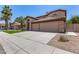 Two-story home with a three-car garage, arched entry, and palm trees at 2461 E Stephens Pl, Chandler, AZ 85225