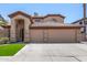 Two-story home with a three-car garage, arched entry, and desert landscaping at 2461 E Stephens Pl, Chandler, AZ 85225