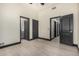 This hallway features wood-style tile and dark-colored doors to bedrooms and bathroom at 2461 E Stephens Pl, Chandler, AZ 85225