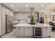 A bright kitchen with stainless steel appliances, a wine cooler, and marble countertops adds a touch of elegance at 2461 E Stephens Pl, Chandler, AZ 85225