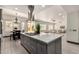 Kitchen with center island gas cooktop provides an open floorplan to dining and living room areas at 2461 E Stephens Pl, Chandler, AZ 85225