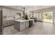 Bright kitchen features a large center island, modern cabinets, stainless appliances, and easy access to the backyard at 2461 E Stephens Pl, Chandler, AZ 85225