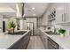 The well-designed kitchen showcases marble countertops, stainless steel appliances, and plentiful storage in stylish cabinets at 2461 E Stephens Pl, Chandler, AZ 85225