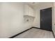 Laundry room featuring overhead storage cabinets and wood-style tile floor at 2461 E Stephens Pl, Chandler, AZ 85225