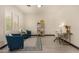 Bright living area featuring modern décor, including a desk, chairs, stylish rug, and window with plantation shutters at 2461 E Stephens Pl, Chandler, AZ 85225