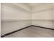 Clean, bright walk-in closet with ample shelf space and modern wood-style flooring for optimal organization at 2461 E Stephens Pl, Chandler, AZ 85225